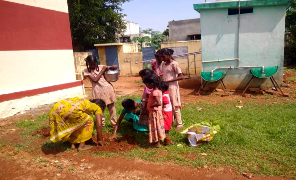 Dalit children plant trees in their village to protect the future. They learn how to care for them and about climate change.